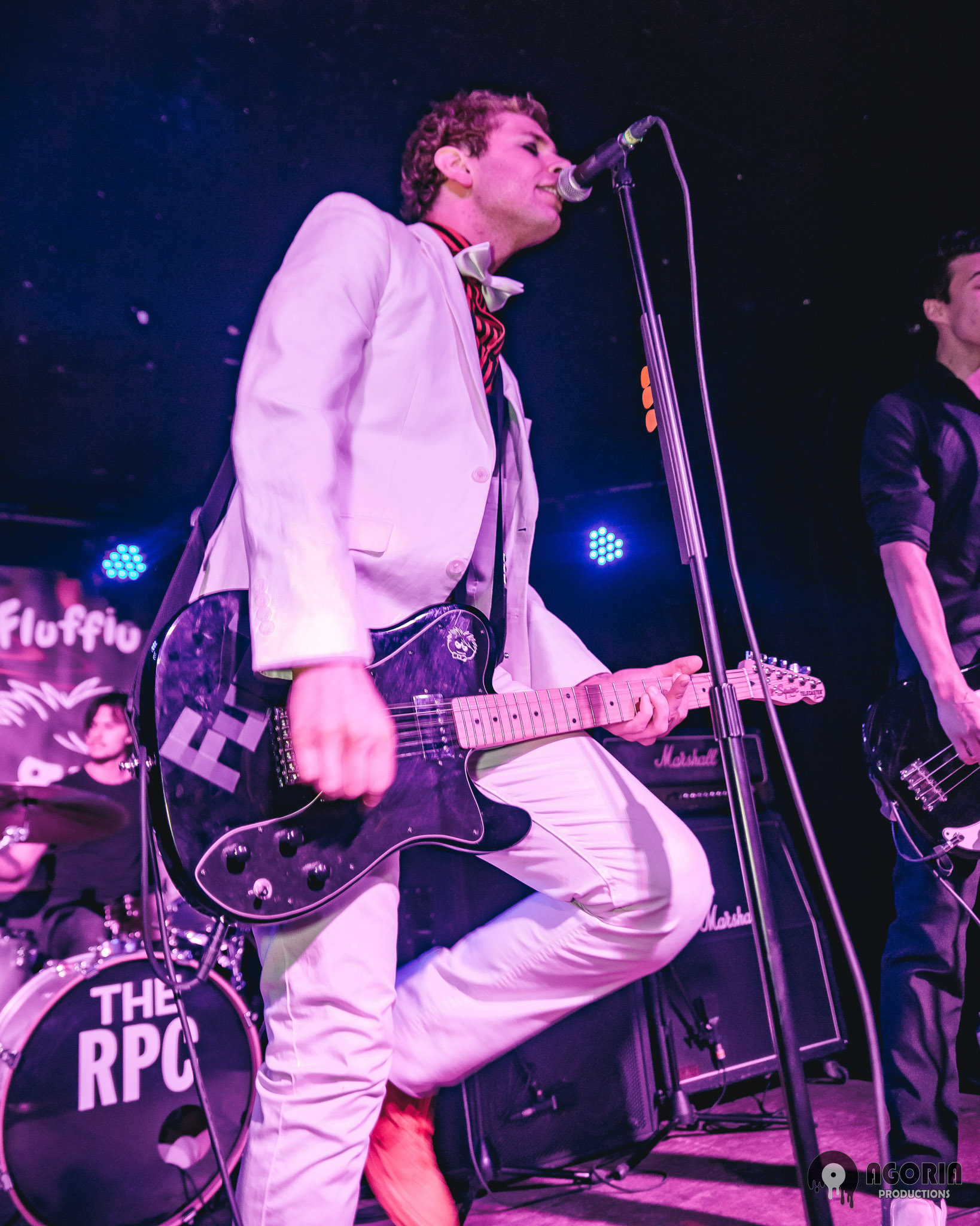 Fluffio singing and playing guitar at concert in toronto at the baby g