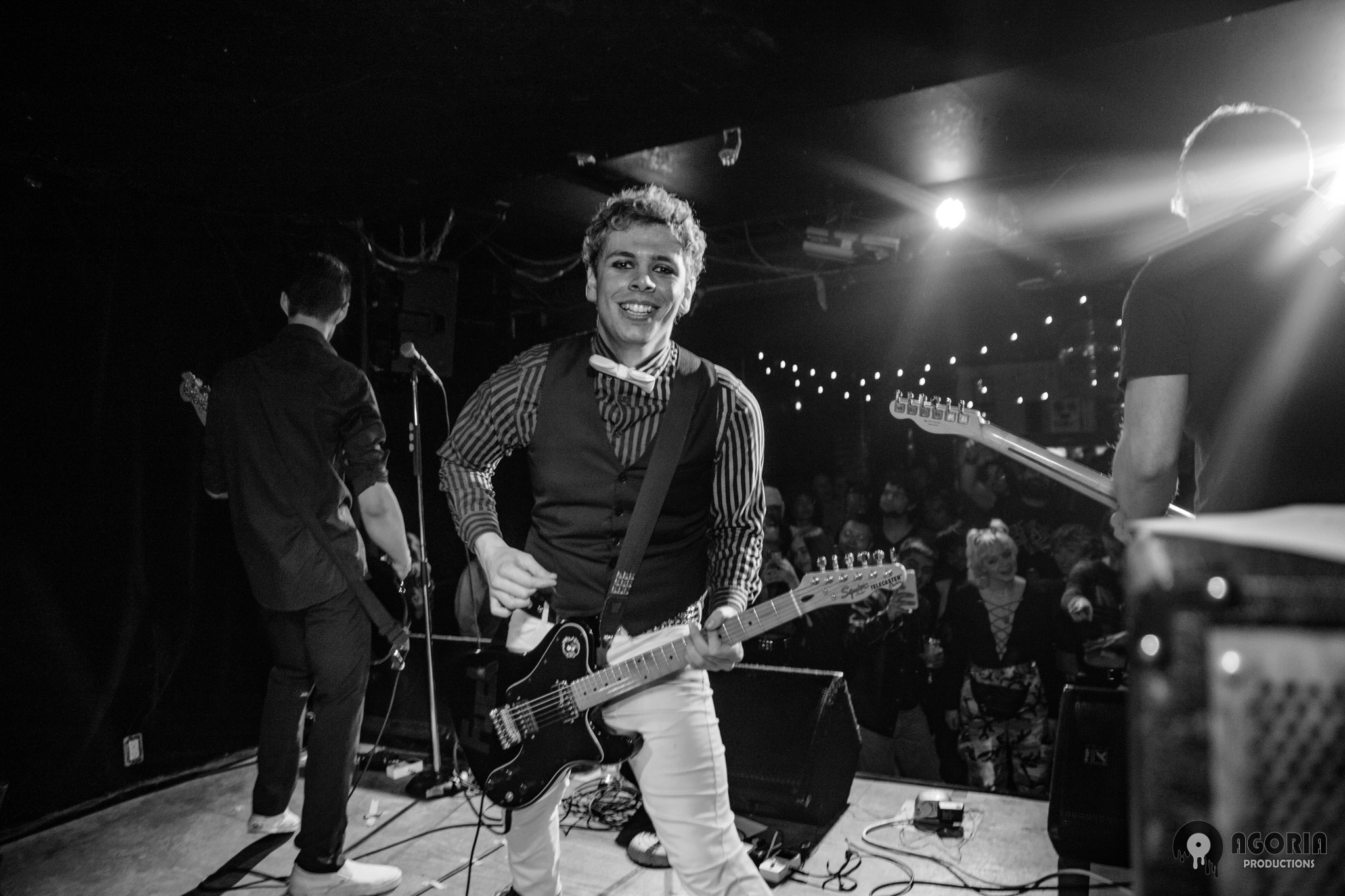 Fluffio performing live at the baby g in toronto smiling at camera with crowd black and white