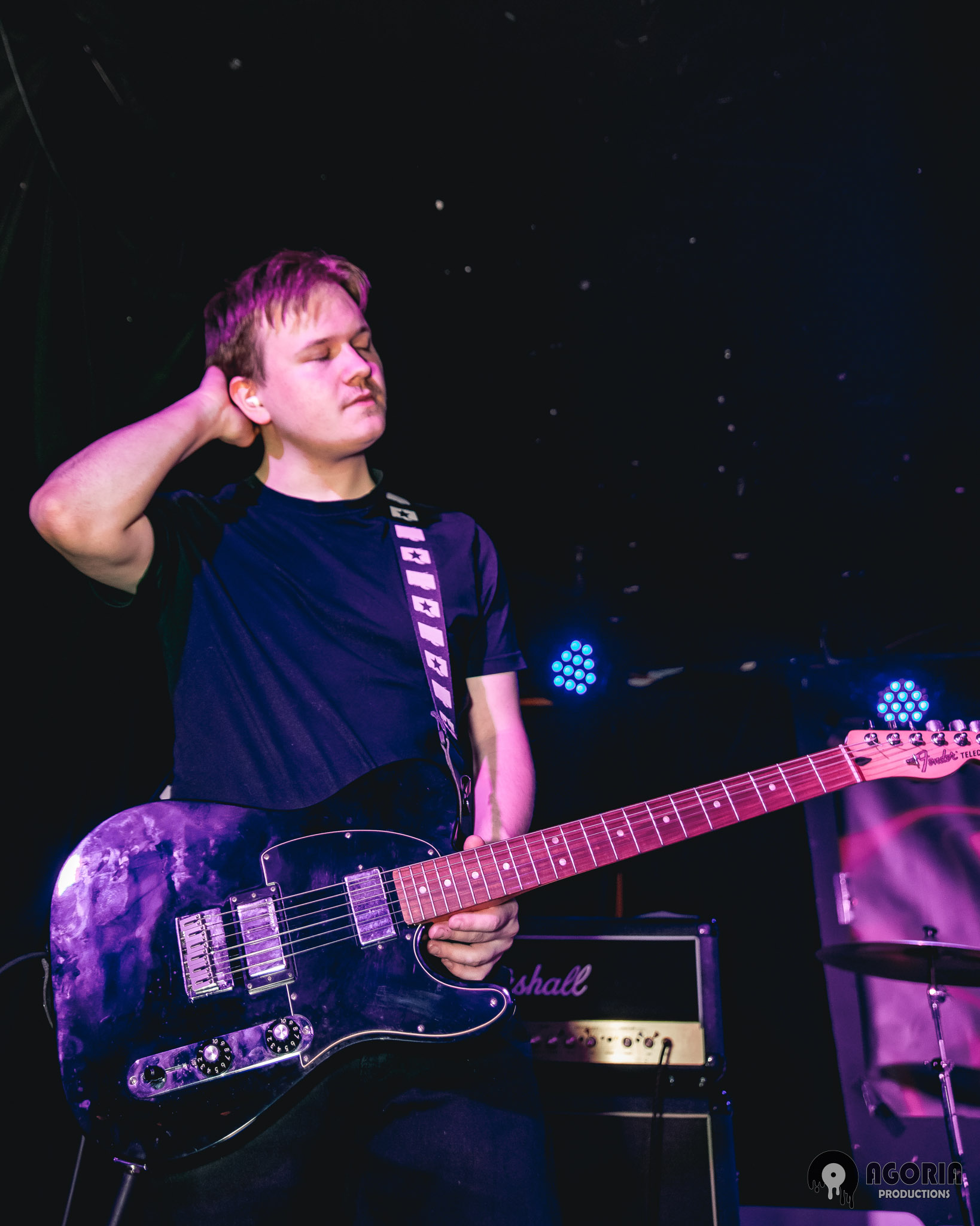 Nick of fluffio and the rpc holding his guitar live