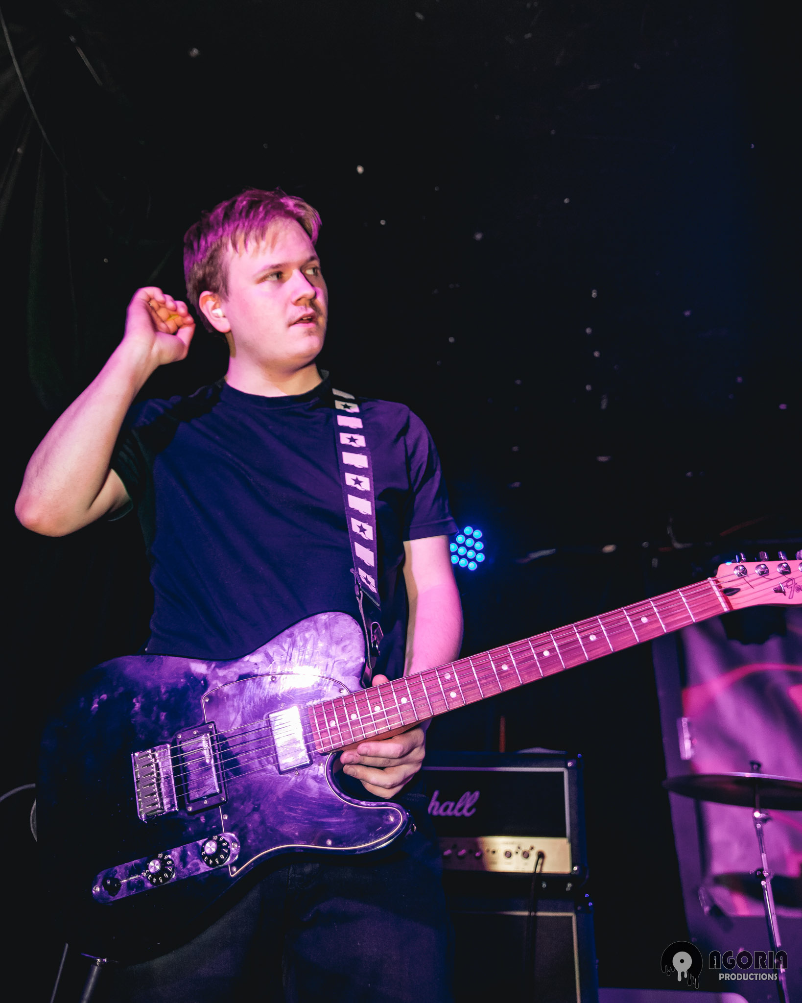 Nick of fluffio and the rpc holding his guitar live