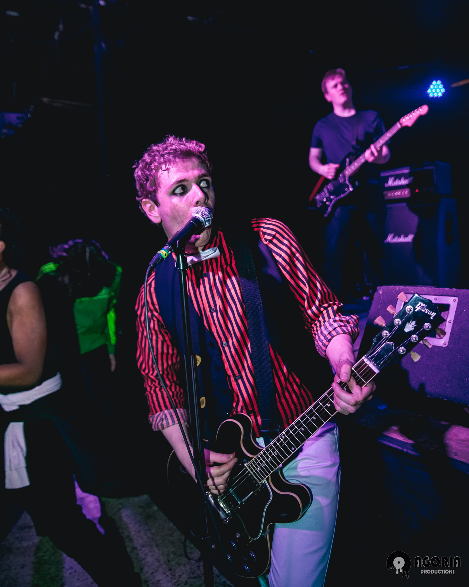 Fluffio portrait closeup with eyeline playing guitar live from the crowd