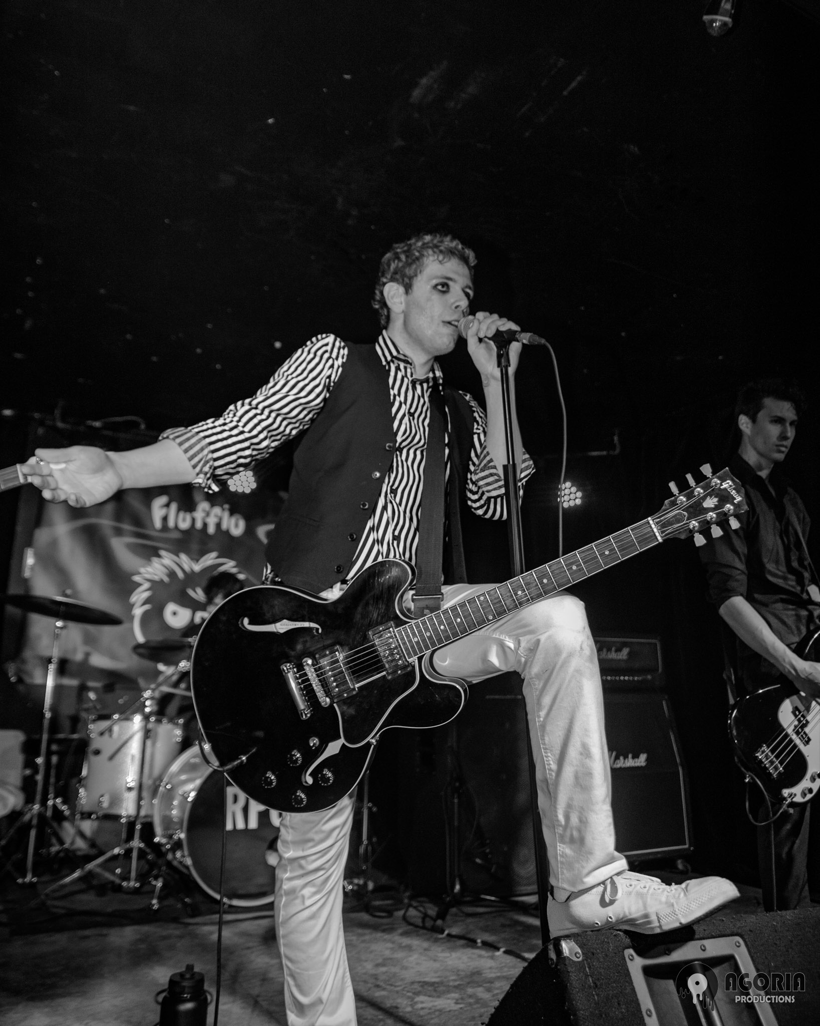 Fluffio with guitar portrait black and white shot playing live with his band