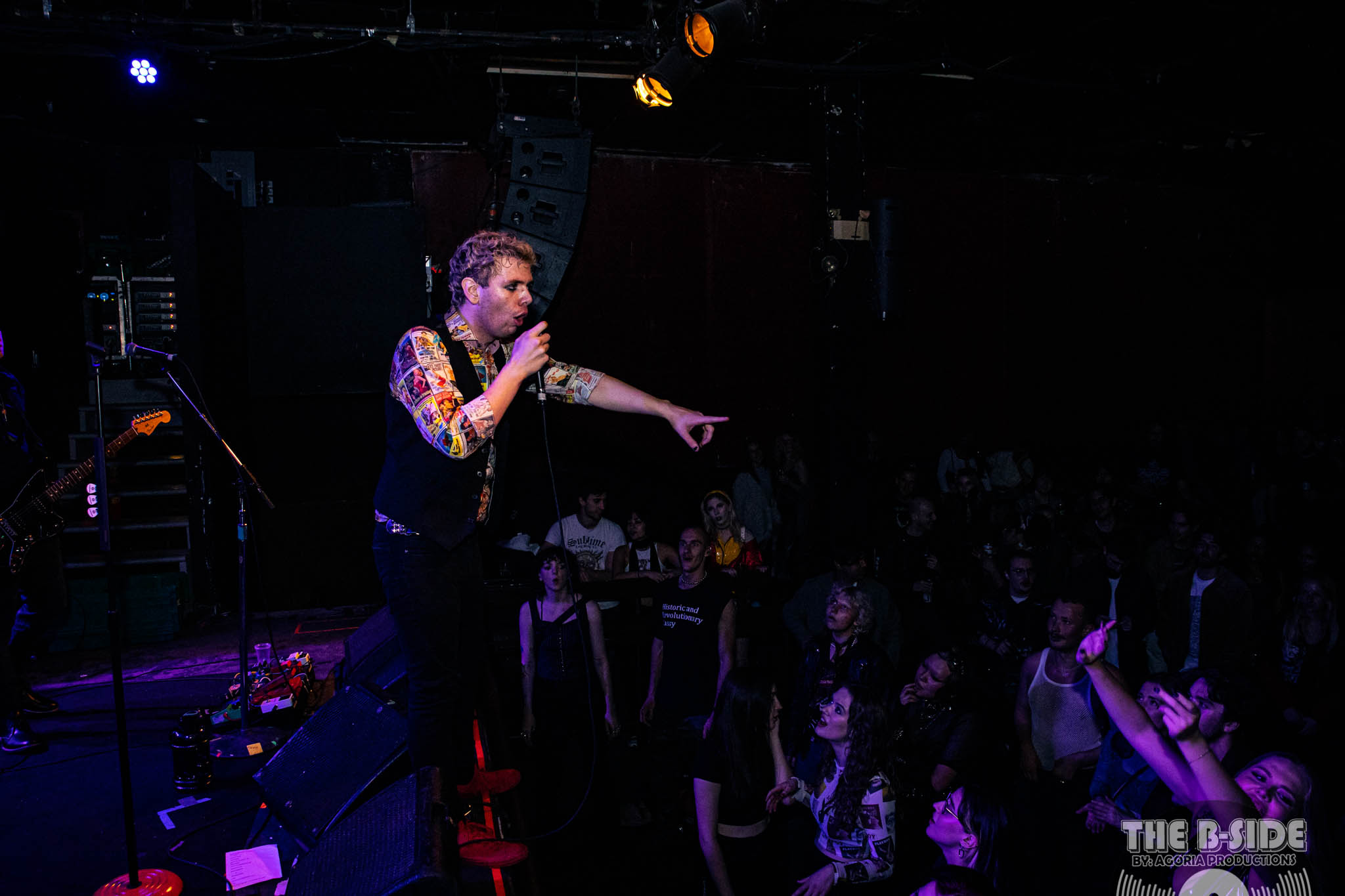 Fluffio on stage at Lee's Palace in Toronto pointing to crowd playing with band The RPC