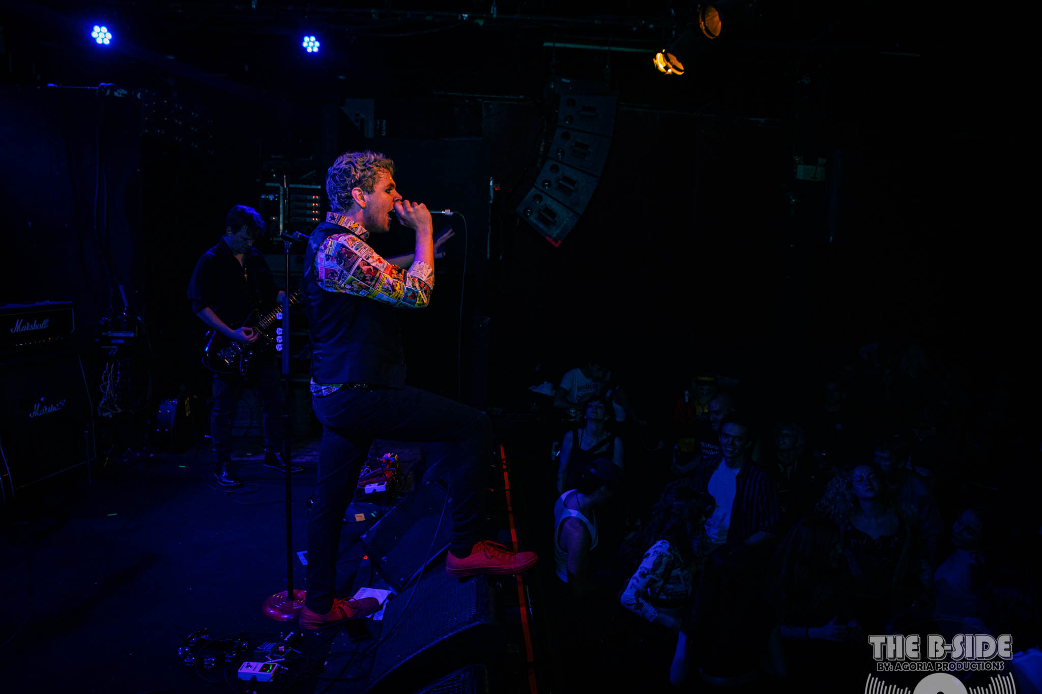 Fluffio singing in front of crowd at Lee's Palace in Toronto with microphone in hand