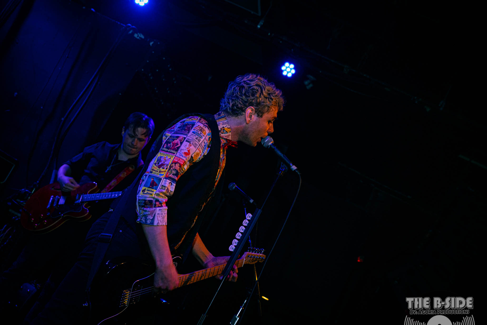 Fluffio singing and playing guitar live on stage at Lee's Palace in Toronto