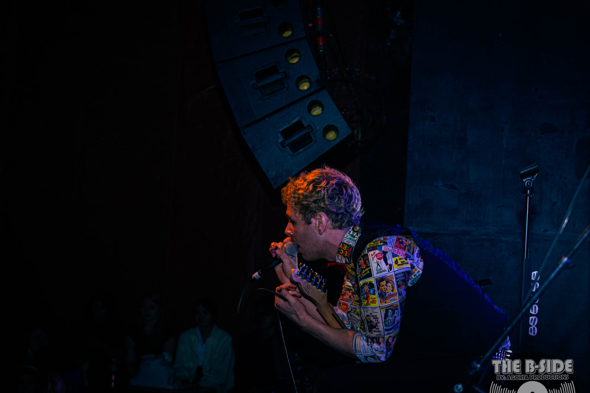 Fluffio on stage at Lee's Palace singing into microphone holding guitar