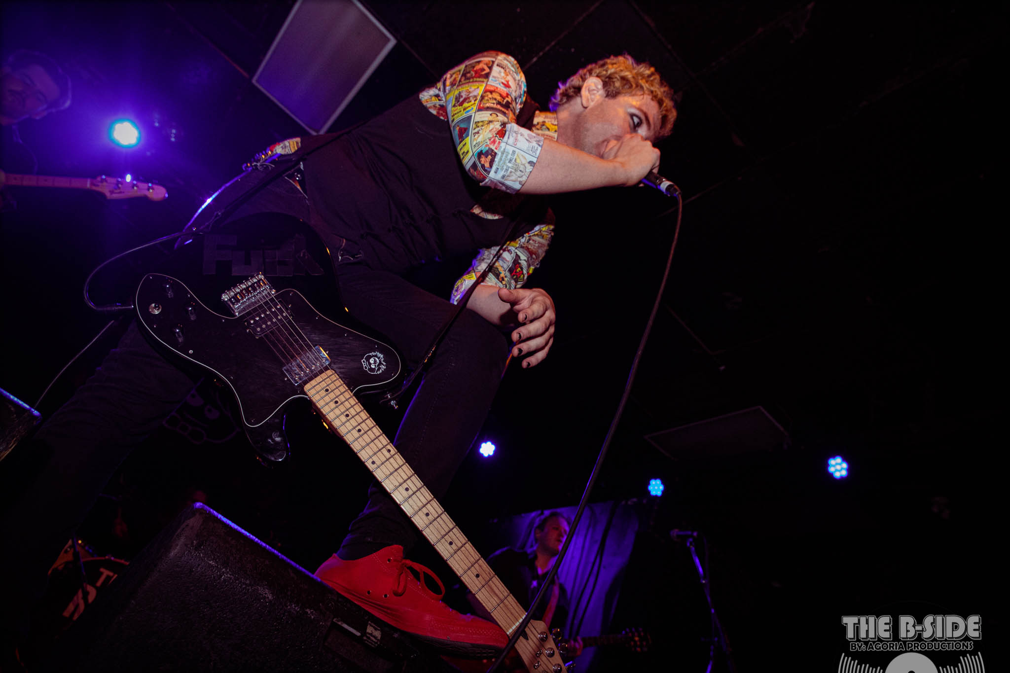Fluffio singing to crowd playing live at Lee's Palace in Toronto on stage